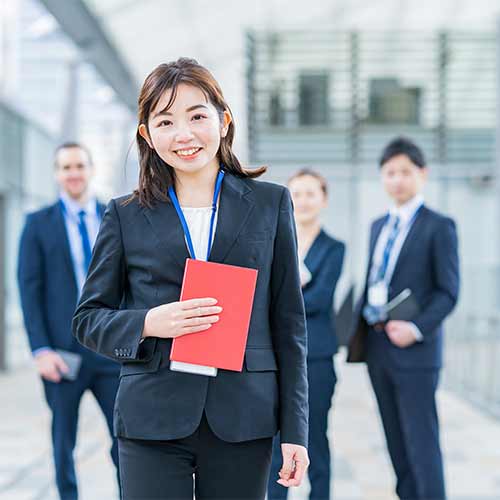 赤い資料を手にしたスーツ姿の担当者